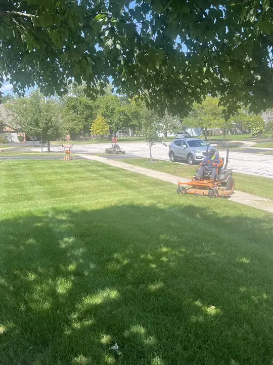 Crew Mowing Large Corner Lawn Chicagoland