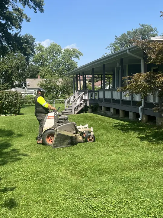 Crew Mowing Lawn At Front Porch Home Chicagoland