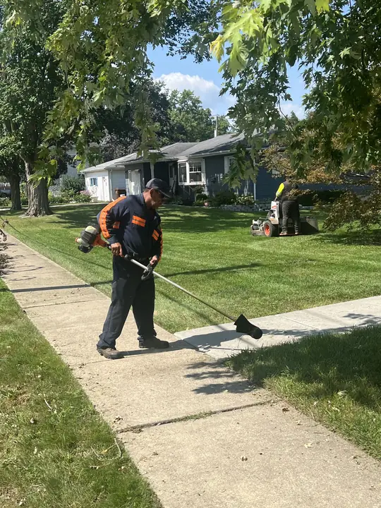 Crew Trimming Along Sidewalk Edge Chicagoland