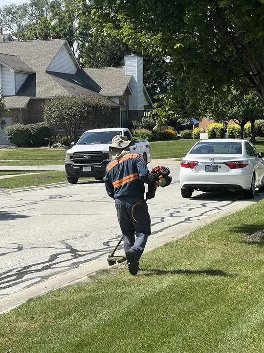 Crew Trimming Residential Driveway Edge Chicagoland