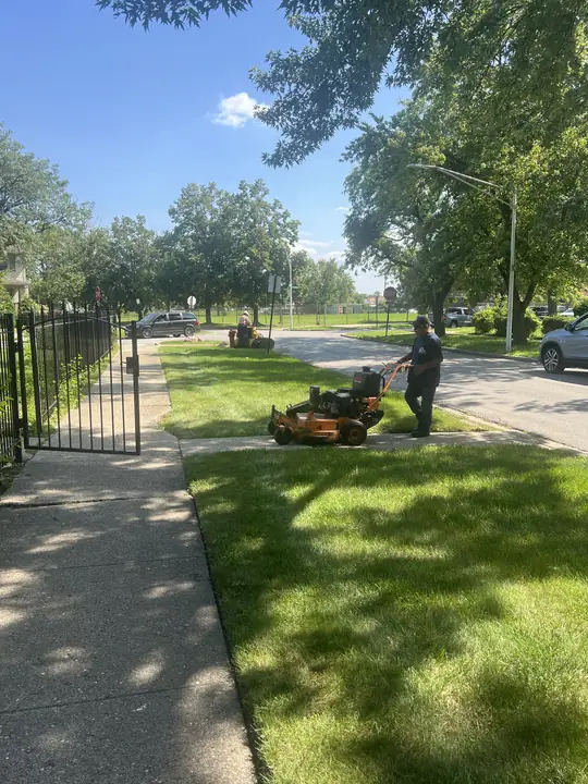 Mower On Apartment Lawn Along Iron Fence Chicagoland