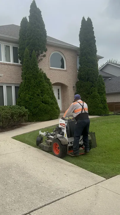 Mowing Beside Arborvitae Brick Home Posen Il